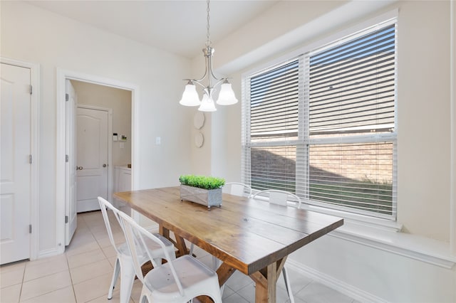 dining room with a notable chandelier and light tile patterned flooring