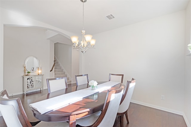 dining area with a notable chandelier and dark wood-type flooring