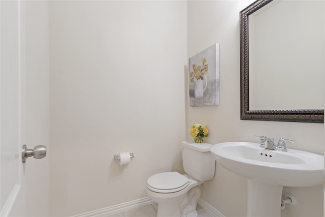 bathroom featuring sink, tile patterned flooring, and toilet