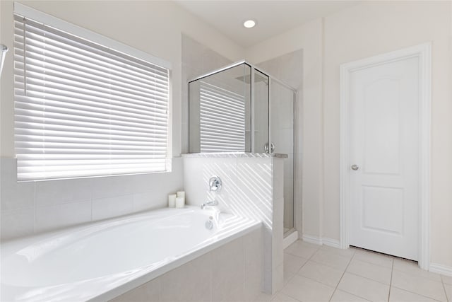 bathroom featuring tile patterned flooring, plenty of natural light, and shower with separate bathtub