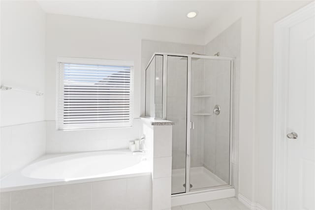 bathroom featuring shower with separate bathtub and tile patterned floors