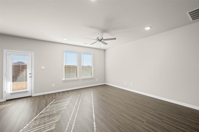 spare room with ceiling fan and dark hardwood / wood-style flooring