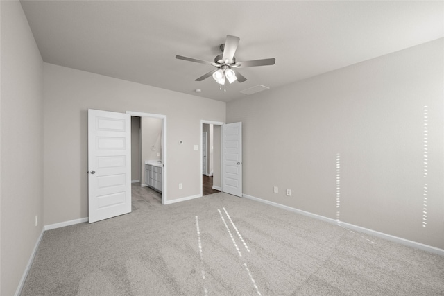 unfurnished bedroom with light carpet, connected bathroom, and ceiling fan