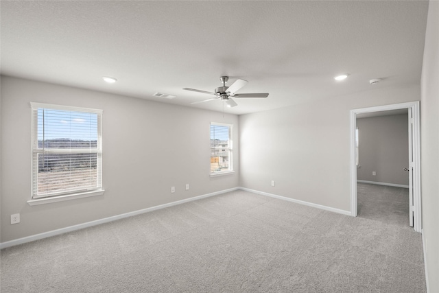 carpeted spare room with ceiling fan