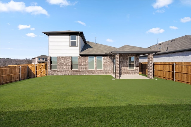 back of property featuring a patio area and a lawn