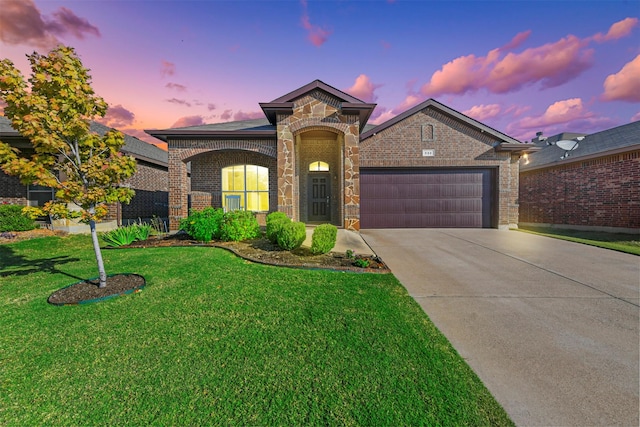 view of front of property with a yard and a garage