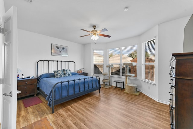 bedroom with ceiling fan and light hardwood / wood-style floors