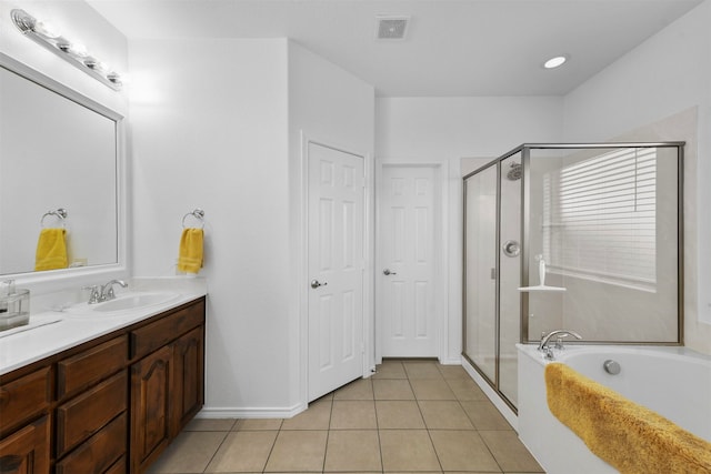 bathroom with tile patterned flooring, vanity, and separate shower and tub