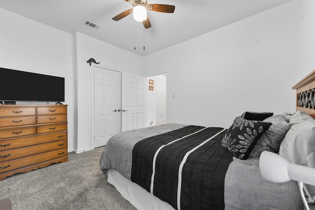 carpeted bedroom featuring ceiling fan and a closet