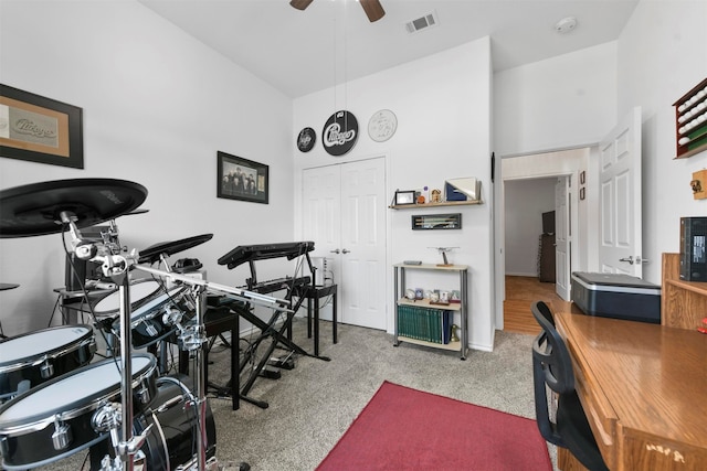 workout room with ceiling fan and carpet floors