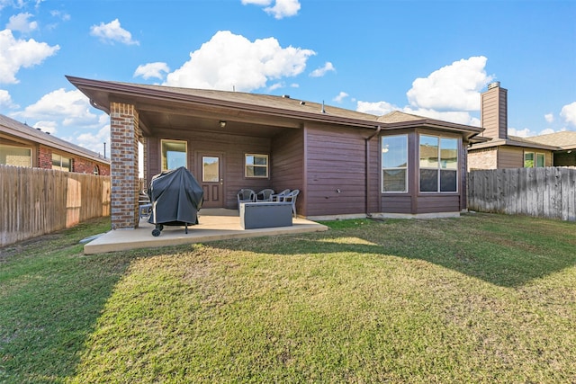 back of property featuring a yard and a patio