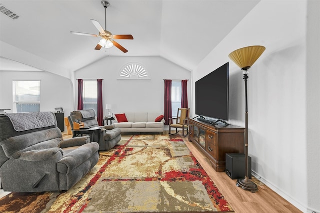 living room featuring ceiling fan, light hardwood / wood-style floors, and vaulted ceiling