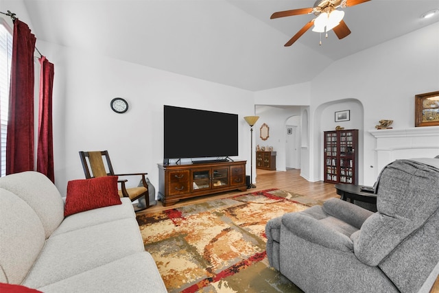 living room with hardwood / wood-style flooring, vaulted ceiling, and ceiling fan