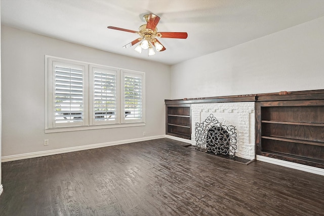 unfurnished living room featuring dark wood-type flooring and ceiling fan