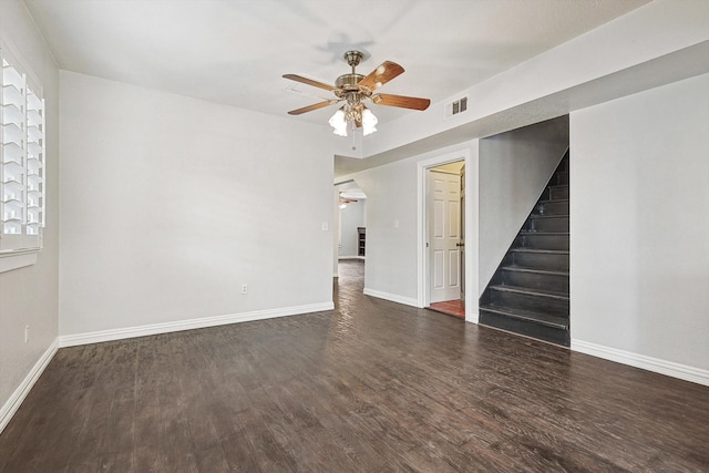 spare room featuring dark wood-type flooring and ceiling fan