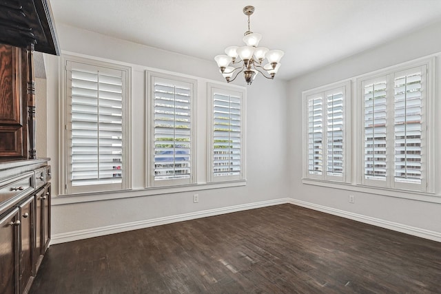 unfurnished dining area featuring a notable chandelier, a wealth of natural light, and dark hardwood / wood-style floors