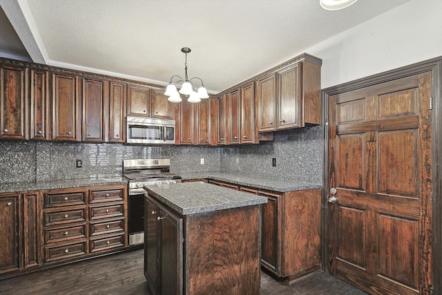 kitchen featuring dark hardwood / wood-style flooring, stainless steel appliances, dark brown cabinets, and a kitchen island