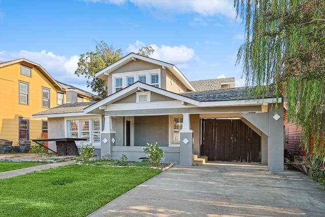 view of front of home with a porch, a front lawn, and a carport