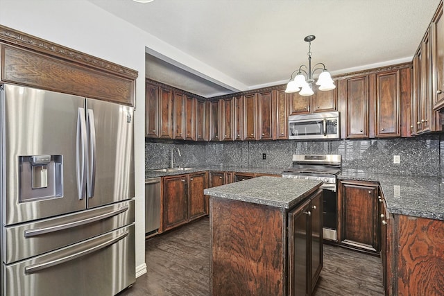 kitchen featuring a kitchen island, appliances with stainless steel finishes, decorative backsplash, and dark hardwood / wood-style flooring