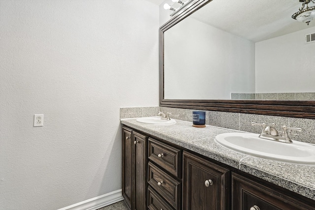 bathroom with vanity and a textured ceiling