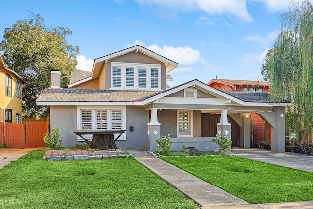 view of front of home featuring covered porch and a front yard