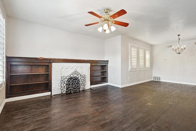 unfurnished living room featuring dark wood-type flooring and ceiling fan with notable chandelier