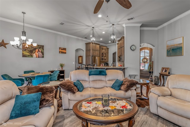 living room featuring light hardwood / wood-style flooring, ornamental molding, and ceiling fan with notable chandelier