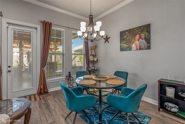 dining room with crown molding, a notable chandelier, wood-type flooring, and plenty of natural light