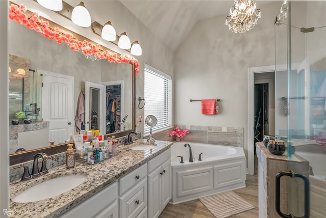 bathroom featuring separate shower and tub, vaulted ceiling, vanity, hardwood / wood-style flooring, and an inviting chandelier