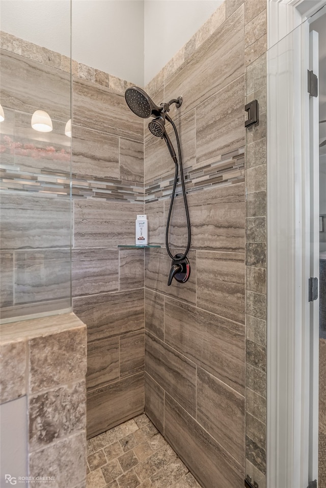 bathroom with a tile shower