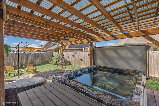 wooden deck featuring a hot tub and a pergola