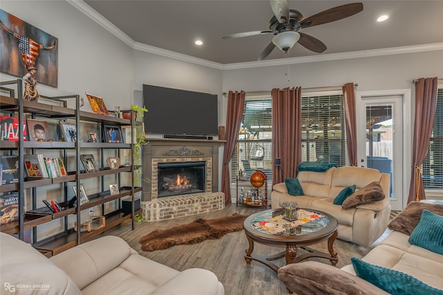 living room featuring a healthy amount of sunlight, hardwood / wood-style flooring, a fireplace, and ceiling fan