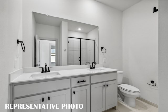 bathroom featuring toilet, vanity, an enclosed shower, and tile patterned floors