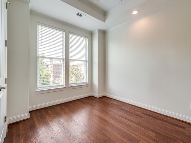 unfurnished room featuring ornamental molding, a healthy amount of sunlight, and dark hardwood / wood-style flooring