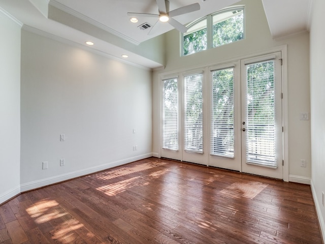 spare room featuring ceiling fan, ornamental molding, dark hardwood / wood-style flooring, and plenty of natural light