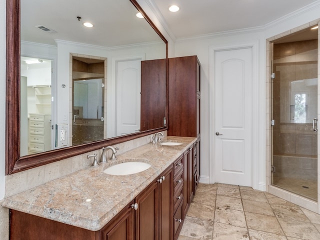 bathroom featuring vanity, ornamental molding, and a shower with shower door