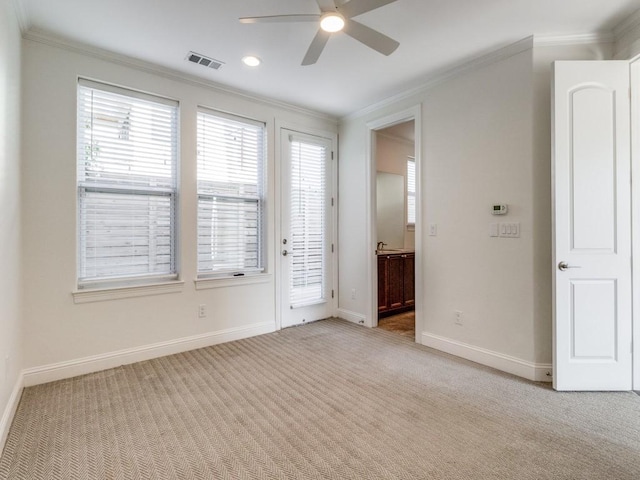 carpeted spare room featuring ceiling fan and ornamental molding