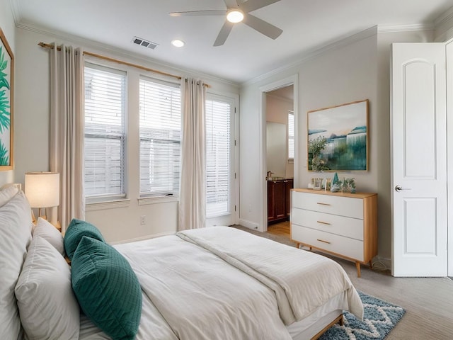 bedroom with light colored carpet, ornamental molding, and ceiling fan