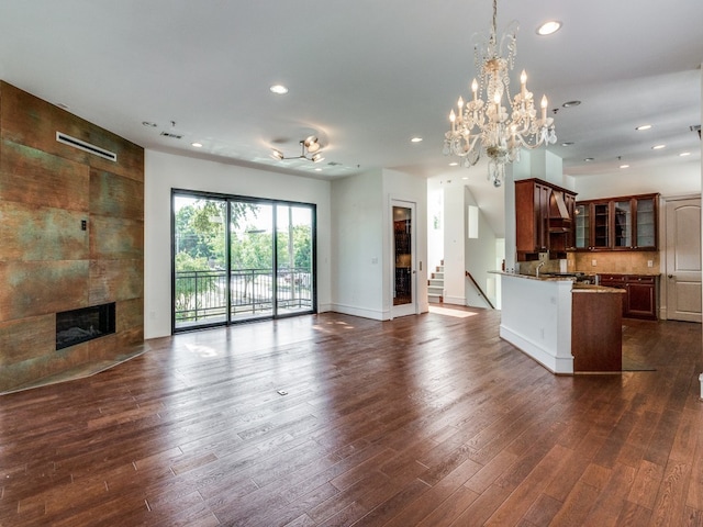 unfurnished living room with dark hardwood / wood-style floors and a tile fireplace