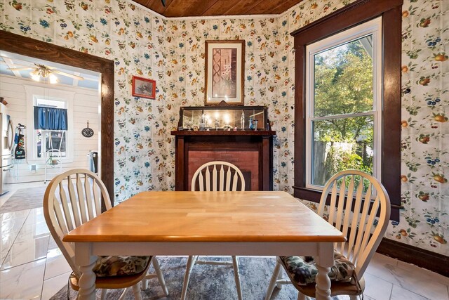 dining space with an inviting chandelier and wooden ceiling