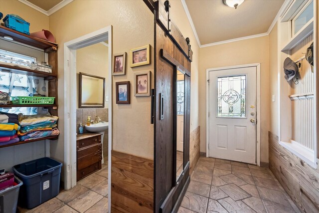 kitchen featuring ornamental molding, appliances with stainless steel finishes, and white cabinets