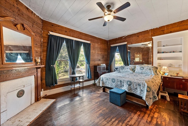 bedroom with dark hardwood / wood-style flooring and wood walls