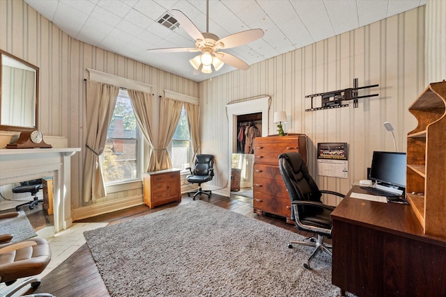 home office with hardwood / wood-style floors and ceiling fan