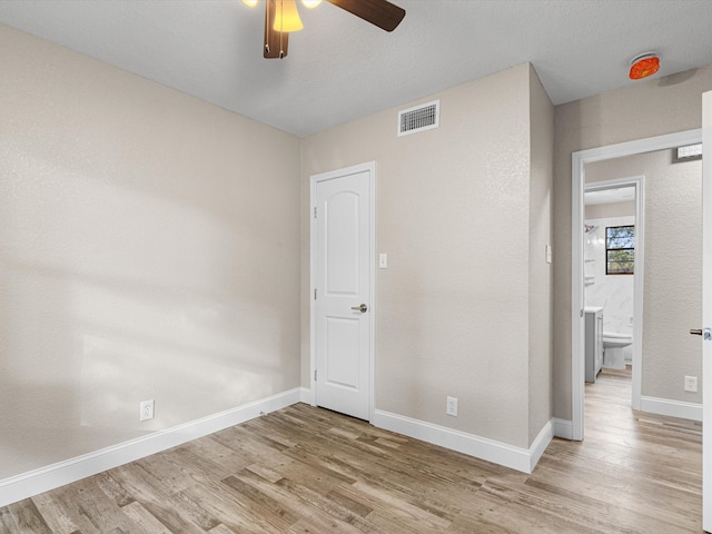 spare room featuring hardwood / wood-style flooring and ceiling fan