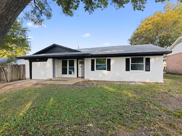 single story home with a front yard and a garage