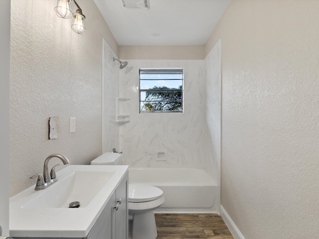 full bathroom featuring vanity, washtub / shower combination, hardwood / wood-style flooring, and toilet