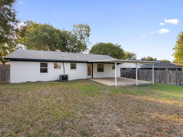 back of house with a patio, central air condition unit, and a lawn