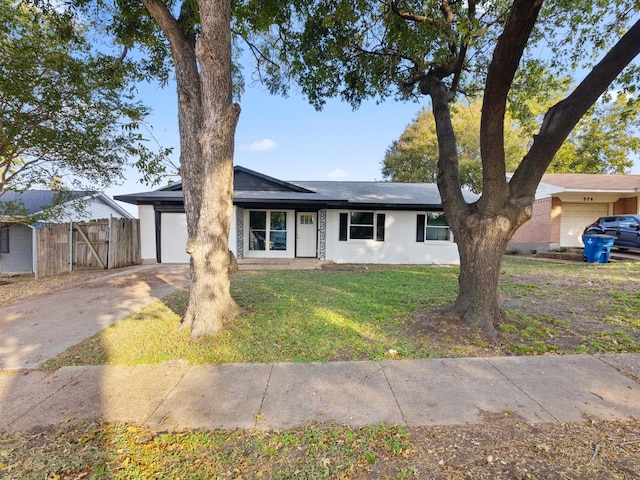 single story home featuring a front lawn and a garage