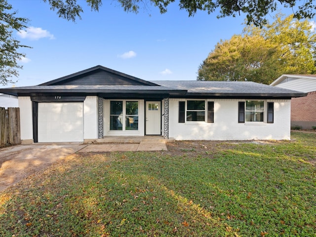 ranch-style home featuring a front lawn and a garage