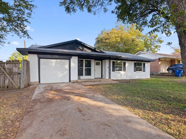 ranch-style home with a front lawn and a garage